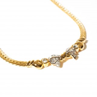 Vintage 1980's Nina Ricci gold tone rhinestone ribbon motif necklace